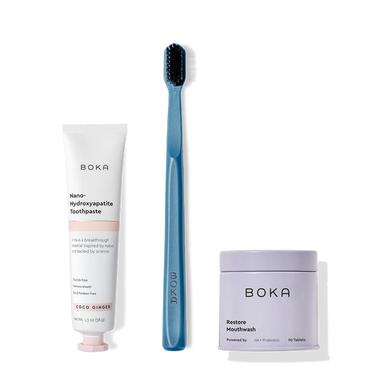 Fresh on the Go: nano-hydroxyapatite toothpaste, charcoal bristle brush, and mouthwash tablets on white.