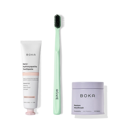 Fresh on the Go nano-hydroxyapatite toothpaste, green toothbrush, and mouthwash tablets on white.
