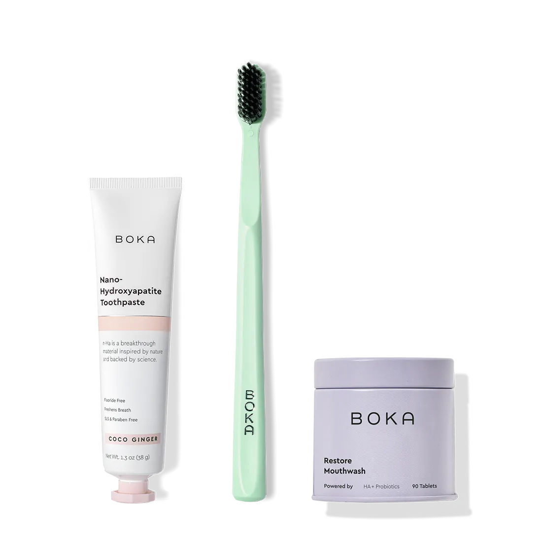 Fresh on the Go: nano-hydroxyapatite toothpaste, charcoal bristle brush, and mouthwash tablets on white.