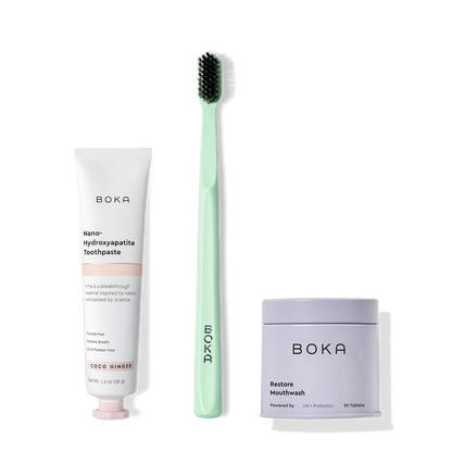 Fresh on the Go: nano-hydroxyapatite toothpaste, charcoal bristle brush, and mouthwash tablets on white.