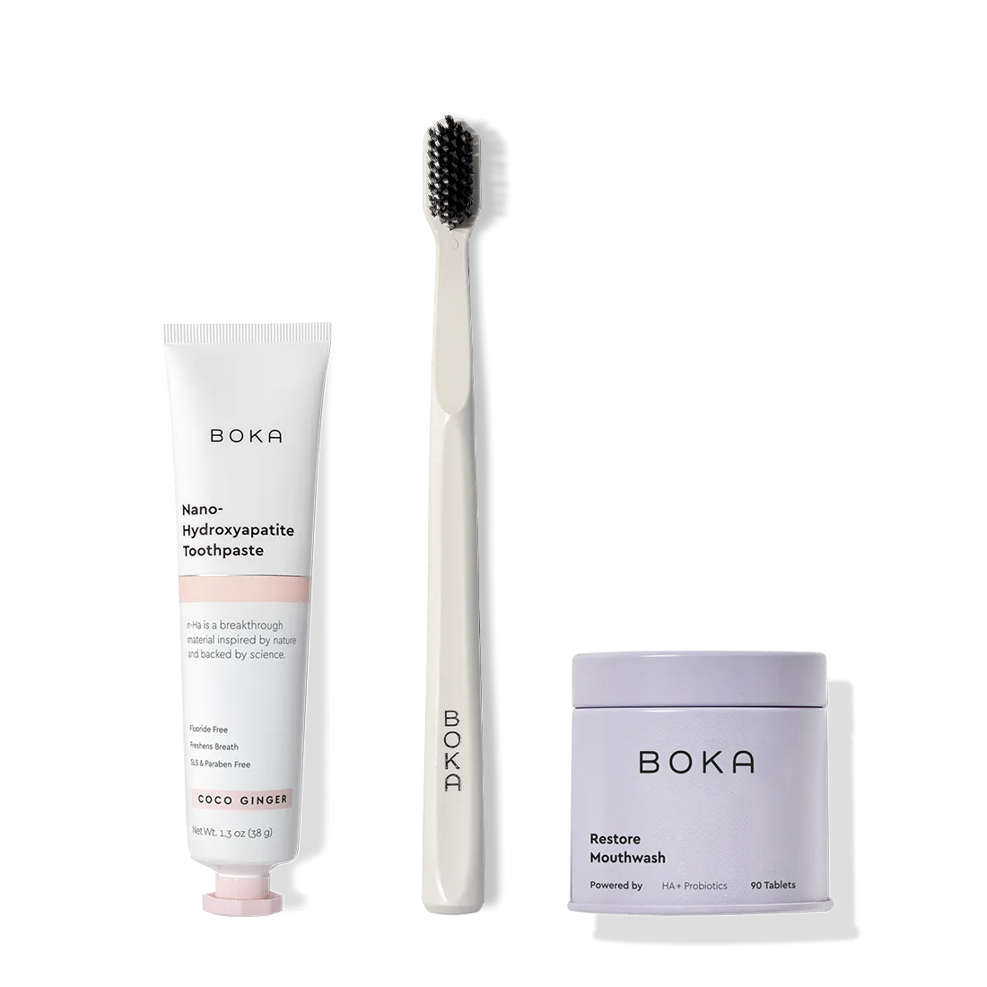Fresh on the Go: nano-hydroxyapatite toothpaste, charcoal bristle brush, and mouthwash tablets on white.