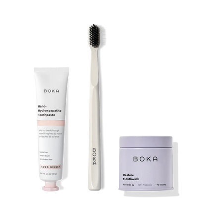 Fresh on the Go: nano-hydroxyapatite toothpaste, charcoal bristle brush, and mouthwash tablets on white.
