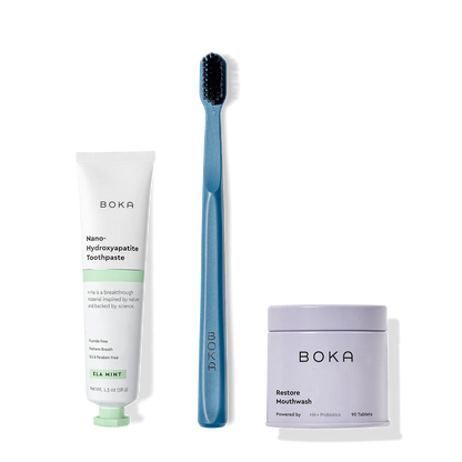 Fresh on the Go: nano-hydroxyapatite toothpaste, charcoal bristle brush, and mouthwash tablets on white.