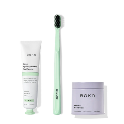 Fresh on the Go: nano-hydroxyapatite toothpaste, charcoal bristle brush, and mouthwash tablets on white.