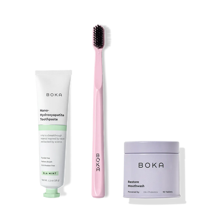 Fresh on the Go: nano-hydroxyapatite toothpaste, charcoal bristle brush, and mouthwash tablets on white.
