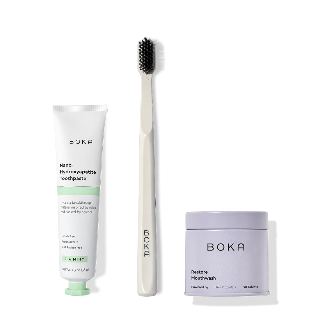 Fresh on the Go: nano-hydroxyapatite toothpaste, charcoal bristle brush, and mouthwash tablets on white.