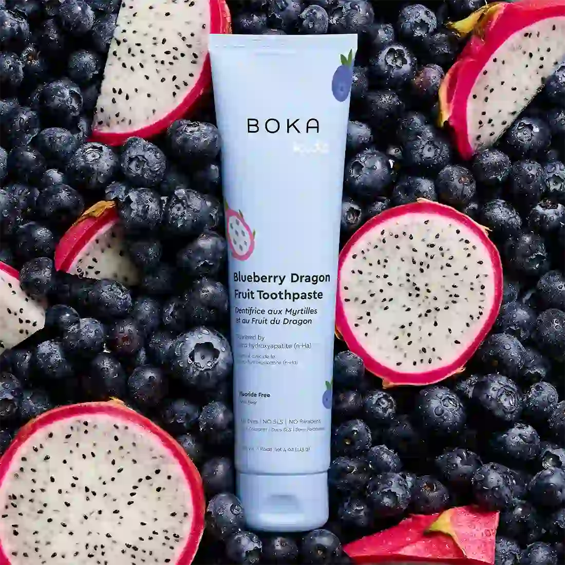 Boka Blueberry Dragon Fruit Toothpaste tube surrounded by blueberries and dragon fruit slices.