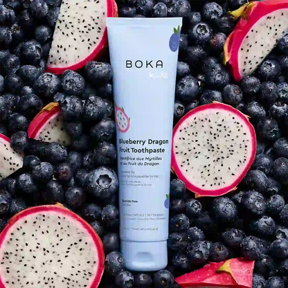 Boka Blueberry Dragon Fruit Toothpaste tube surrounded by blueberries and dragon fruit slices.