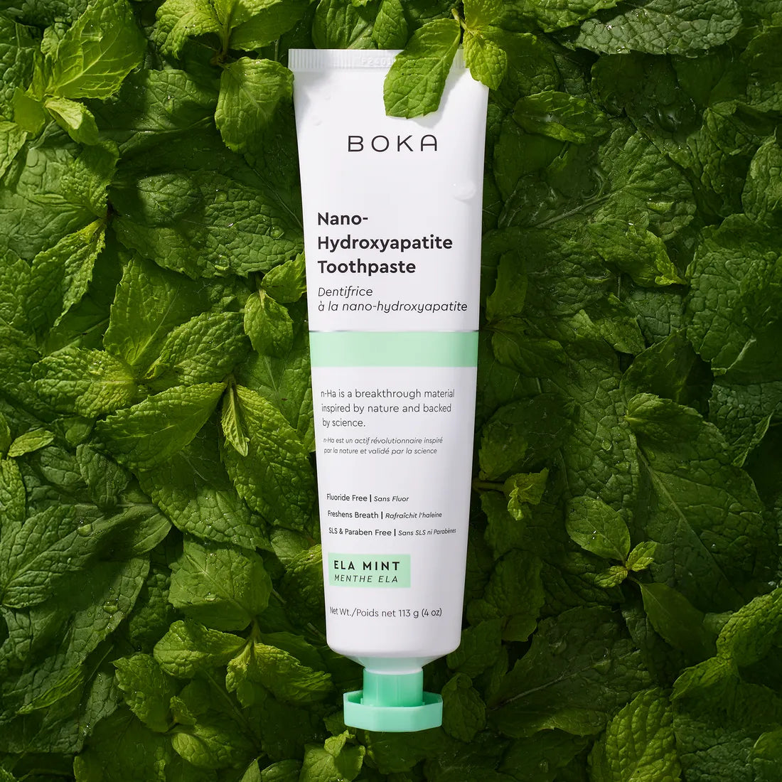 Boka Nano-Hydroxyapatite Toothpaste tube on a green leaf background
