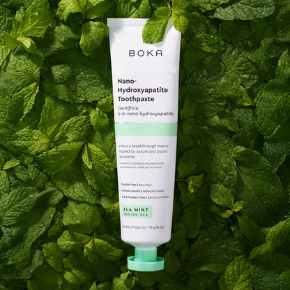 Boka Nano-Hydroxyapatite Toothpaste tube on a green leaf background