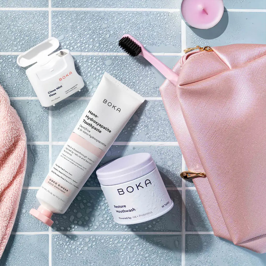 Boka dental care products including toothpaste, mouthwash, and a toothbrush on a tiled surface.