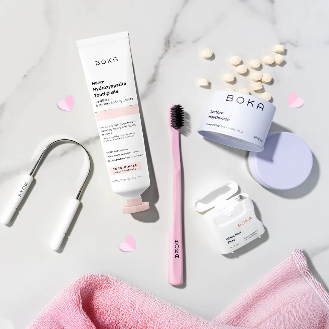 Boka dental care products including toothpaste, toothbrush, and mouthwash on a marble surface.