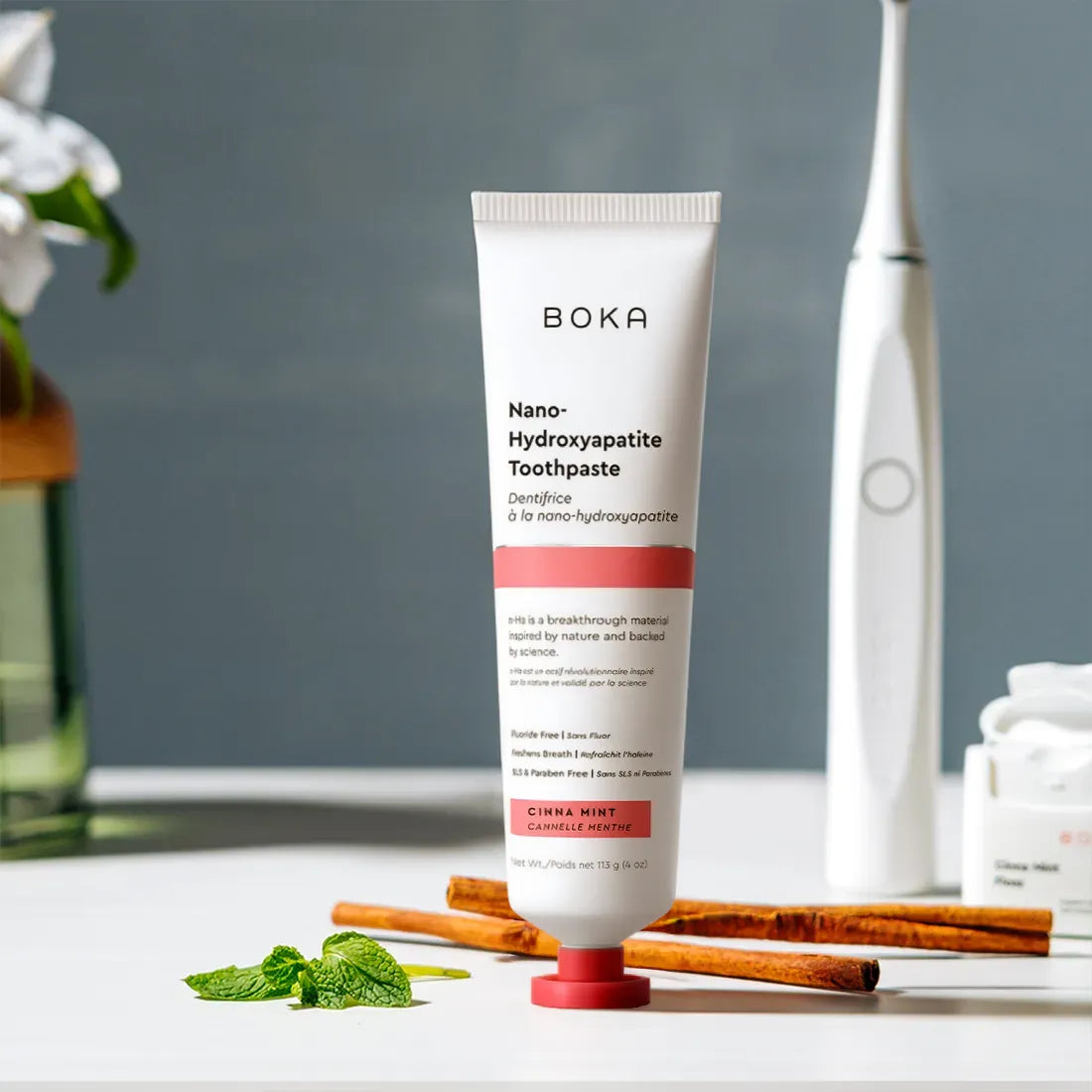 Boka toothpaste tube with a toothbrush and cinnamon sticks on a table