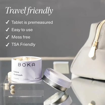 Boka mouthwash tablets with a travel-friendly container on a reflective surface.