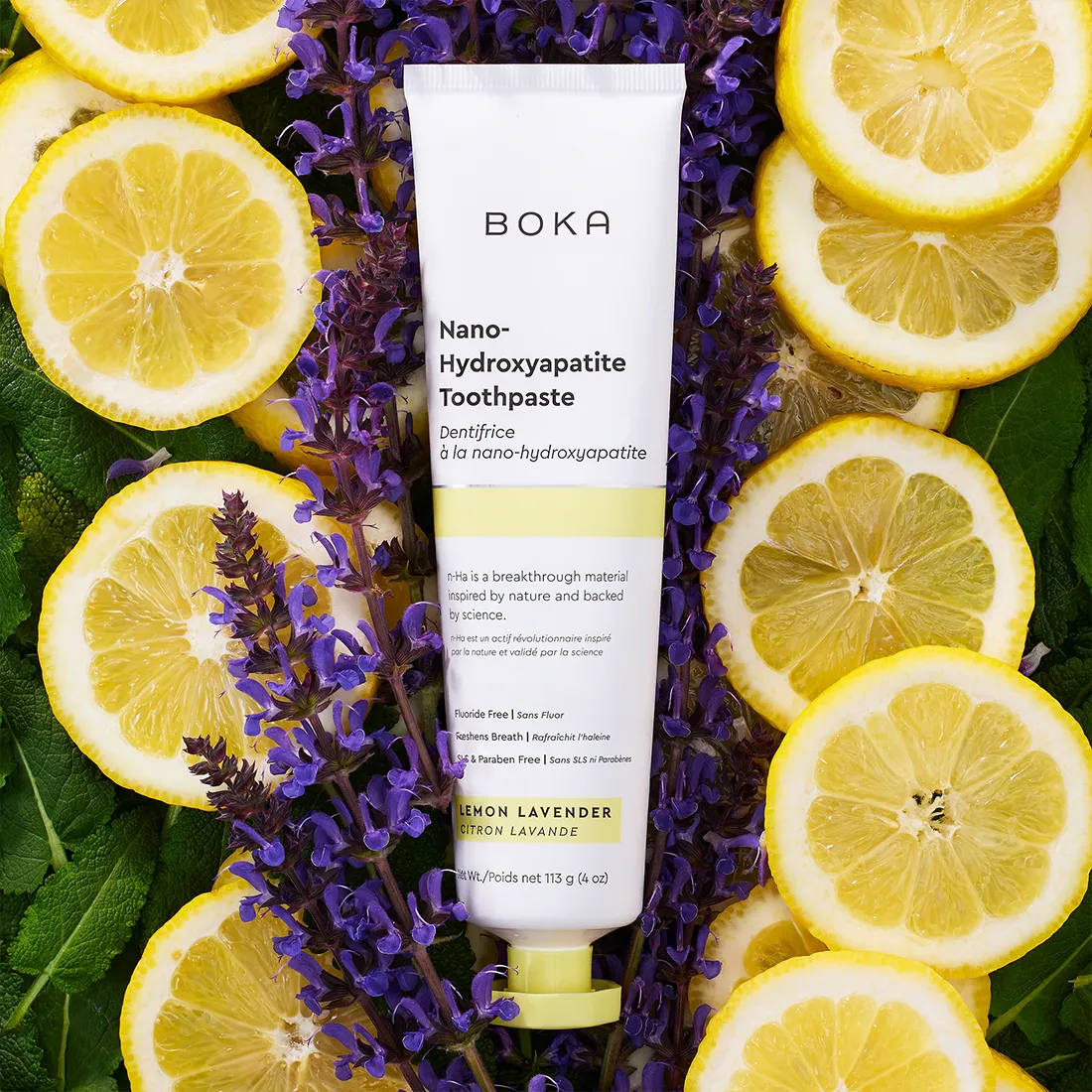 Boka Nano-Hydroxyapatite Toothpaste surrounded by lemon slices and lavender flowers