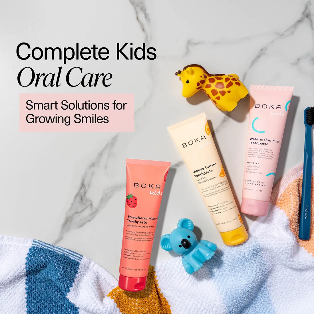 Boka kids' oral care products on a marble background with toys.