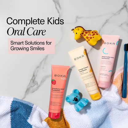 Boka kids' oral care products on a marble background with toys.