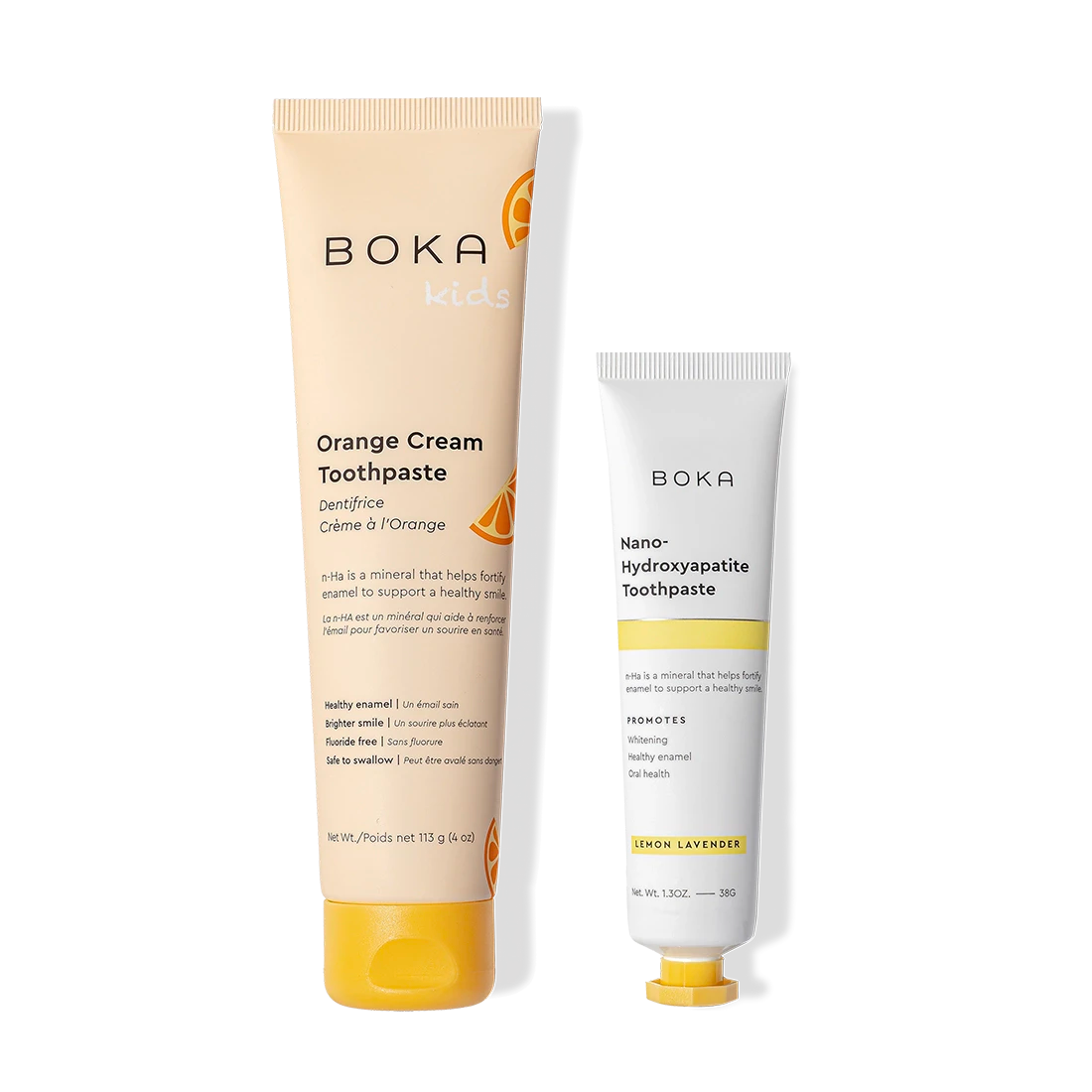 Two tubes of Boka Home & Away toothpaste: orange cream for kids, lemon lavender for enamel care.