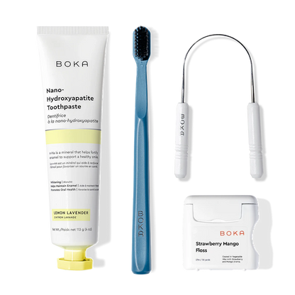 Boka Starter Kit with nano-hydroxyapatite toothpaste, charcoal toothbrush, floss & holder on white.