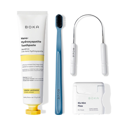 Starter Kit: toothpaste, blue brush with charcoal bristles, floss & tongue cleaner on white.