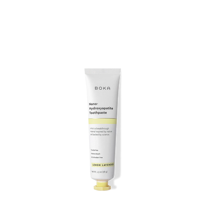 A white tube of Lemon Lavender Travel Size n-Ha Toothpaste on a black background.