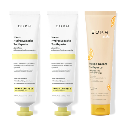 Two bottles of Boka Nano-Hydroxyapatite Toothpaste and a tube of Boka Kids Orange Cream Toothpaste on a white background.