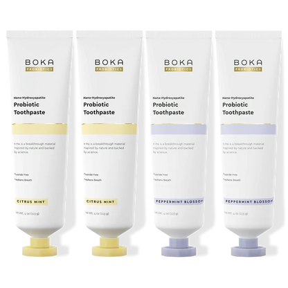 Four Boka Probiotic Toothpaste tubes in different flavors on a white background