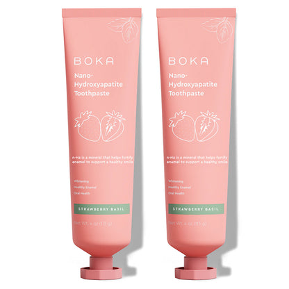Two pink tubes of Strawberry Basil n-Ha Toothpaste with strawberry graphics, fluoride-free.