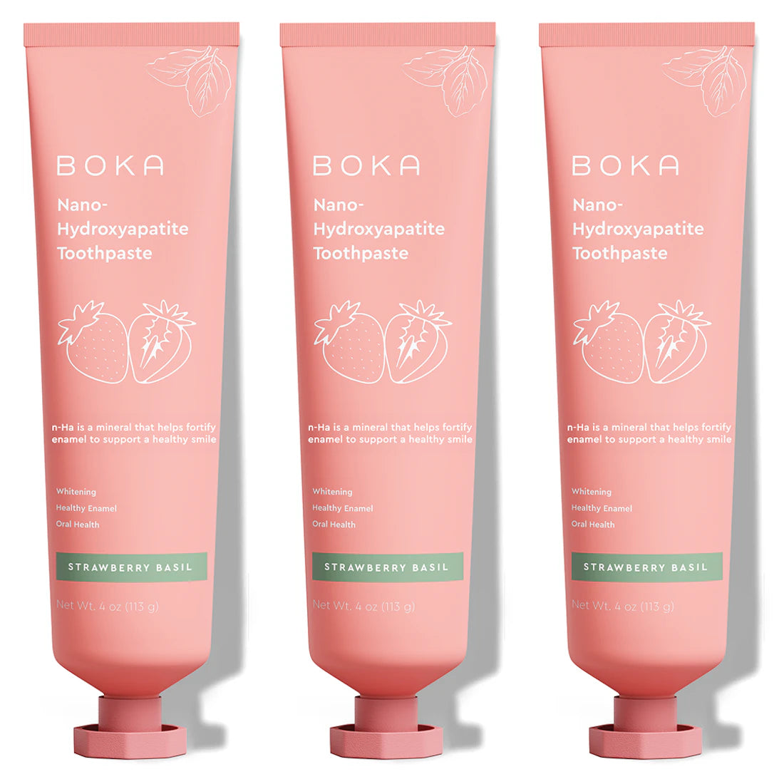 Three upright tubes of Strawberry Basil n-Ha Toothpaste, pink color, fluoride-free.