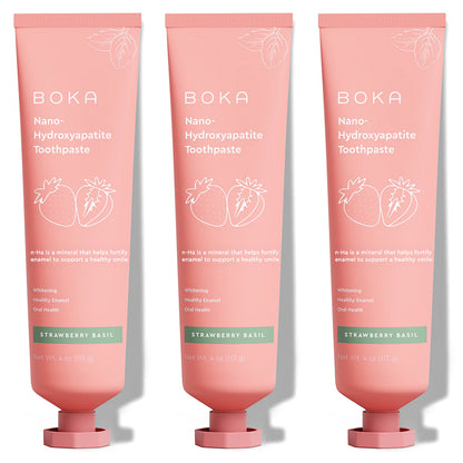 Three upright tubes of Strawberry Basil n-Ha Toothpaste, pink color, fluoride-free.
