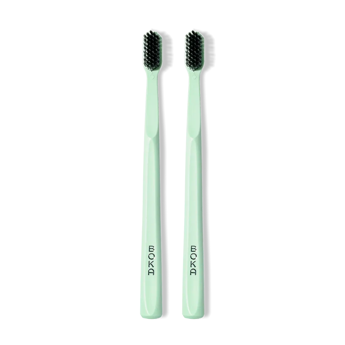 Two Classic Toothbrush 2-Packs in light green with activated charcoal bristles for gentle cleaning.