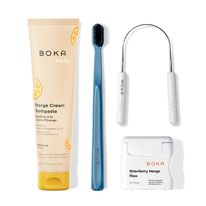 Boka dental care products including toothpaste, toothbrush, Tongue Scraper and floss on a white background