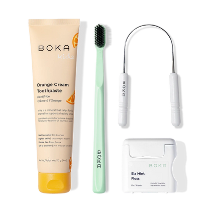 Boka Starter Kit: kids nano-hydroxyapatite toothpaste, green charcoal toothbrush, floss, tongue scraper.
