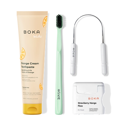 Boka dental care products including toothpaste, toothbrush, Tongue Scraper and floss on a white background