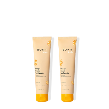 Two tubes of Boka Orange Cream Toothpaste on a white background