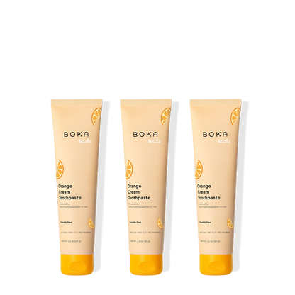 Three tubes of Boka Orange Cream Toothpaste on a white background
