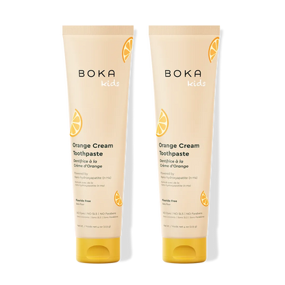 Two tubes of Boka Orange Cream Toothpaste on a white background