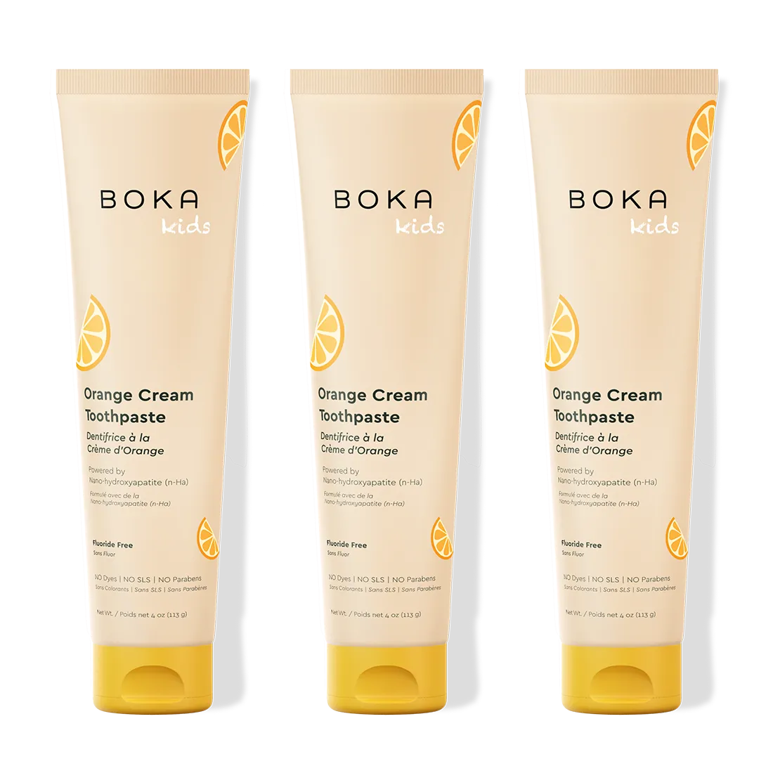 Three tubes of Boka Kids Orange Cream Toothpaste on a white background