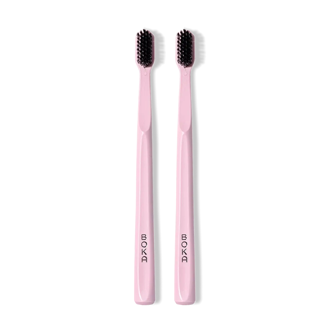 Classic Toothbrush 2-Pack: two pink brushes with black charcoal bristles, side by side.