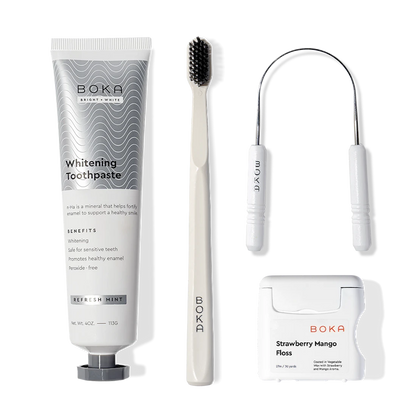 Starter Kit with nano-hydroxyapatite toothpaste, toothbrush, floss & dental tool on white.