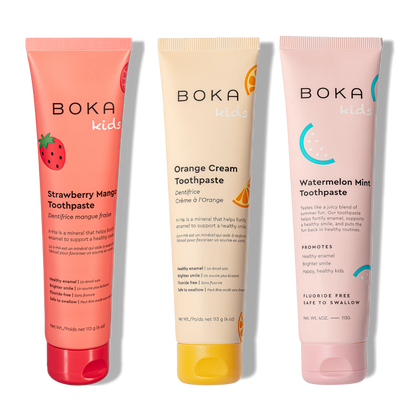 Three tubes of Boka toothpaste with different flavors on a white background