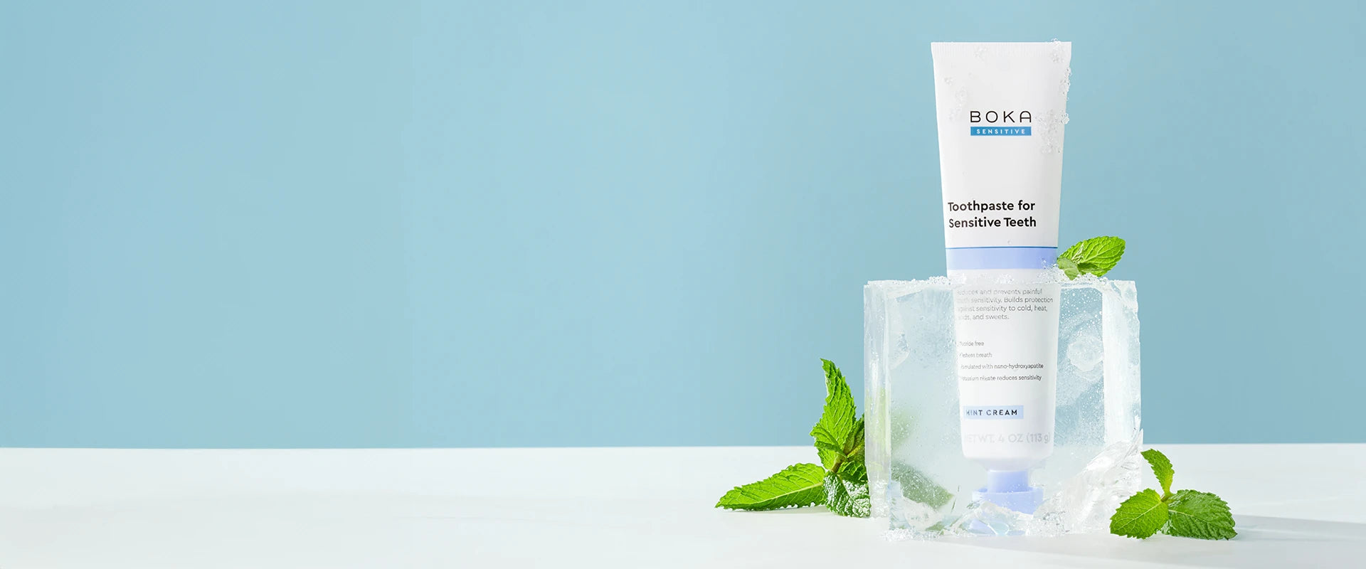 Boka toothpaste for sensitive teeth on a white surface with a light blue background