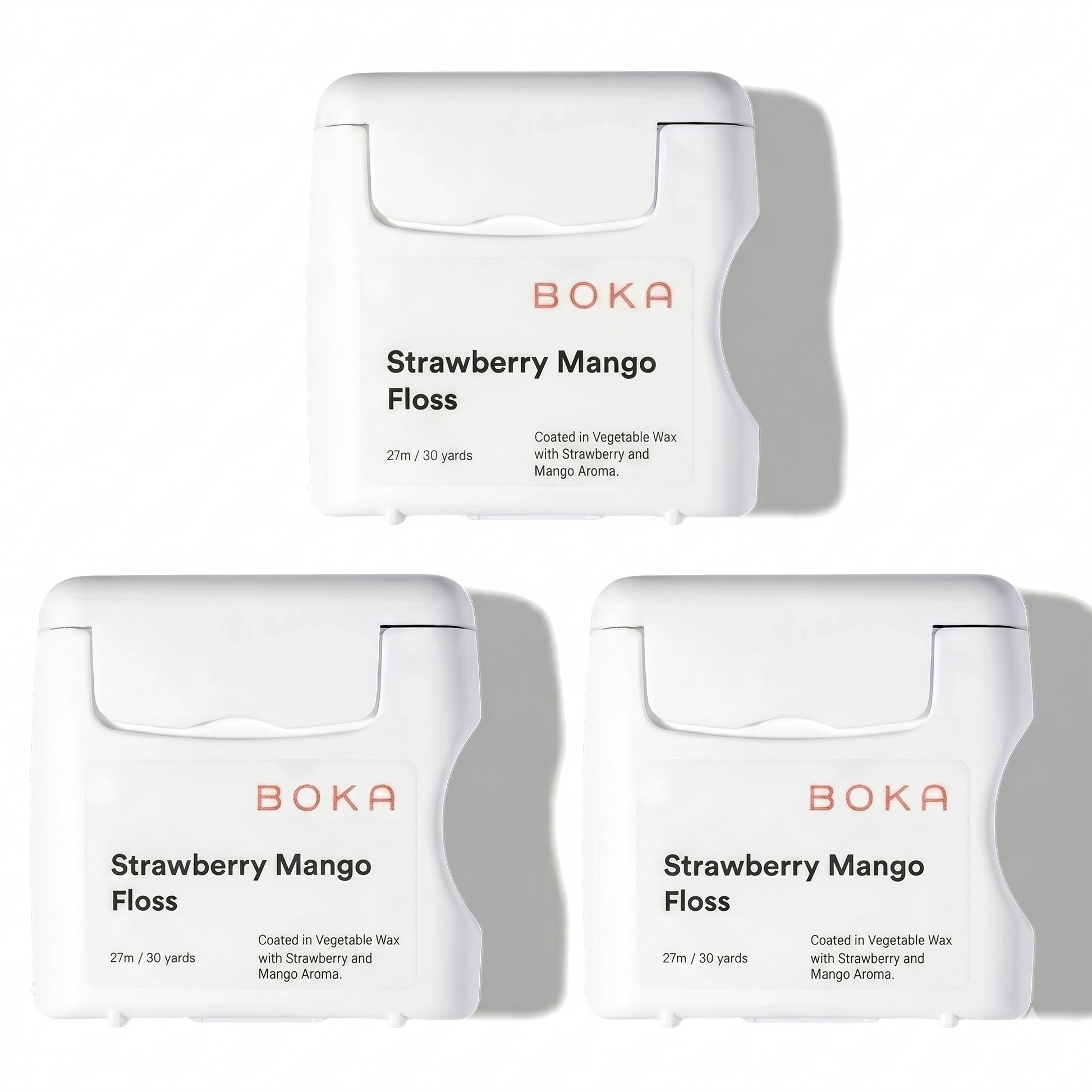 Three packages of Boka Strawberry Mango Floss on a white background