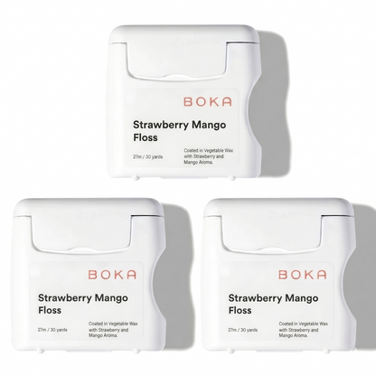 Three packages of Boka Strawberry Mango Floss on a white background