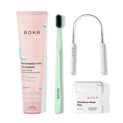 Boka dental care products including toothpaste, toothbrush, Tongue Scraper and floss on a white background