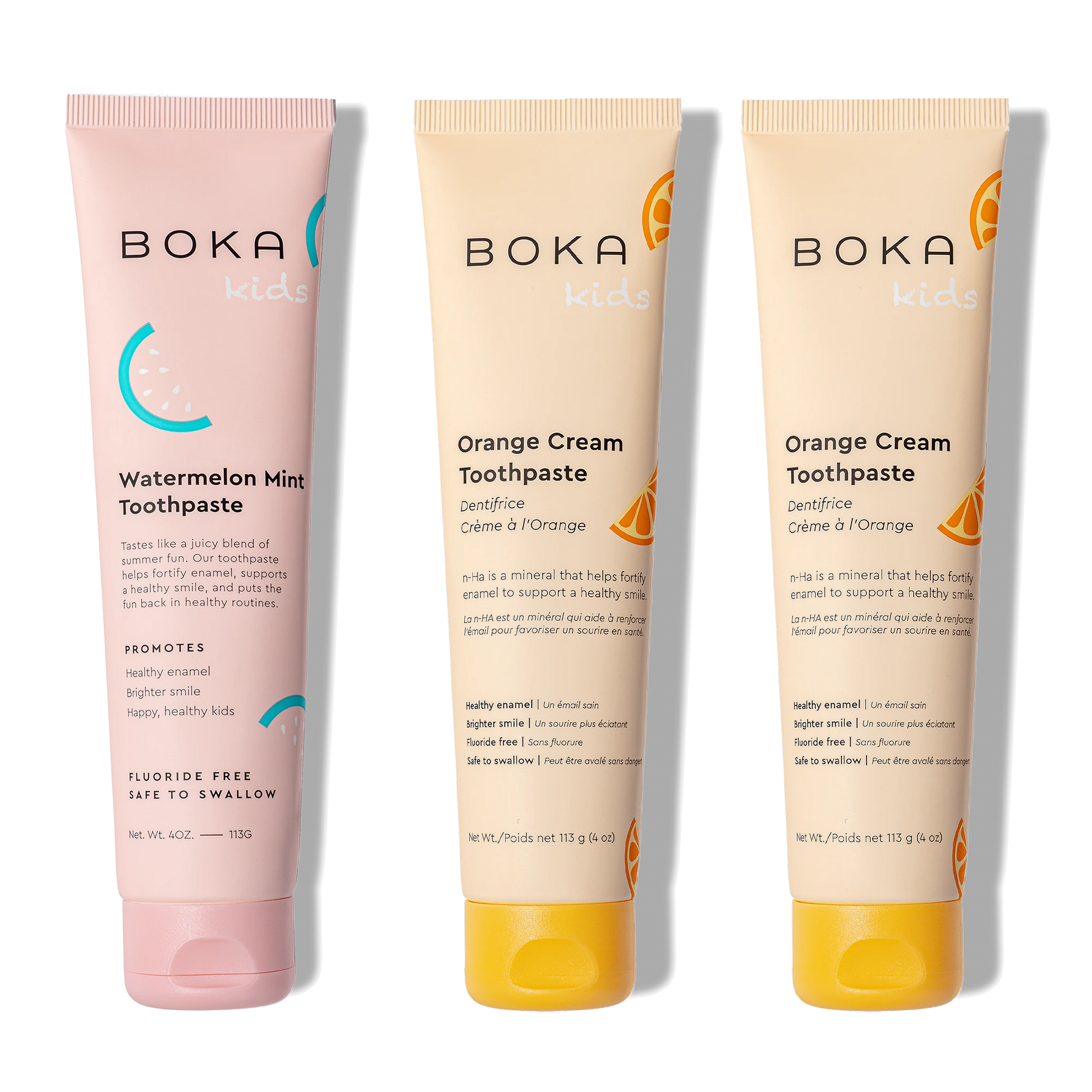 Three tubes of Boka toothpaste, two in orange cream flavor and one in watermelon mint flavor, on a white background.
