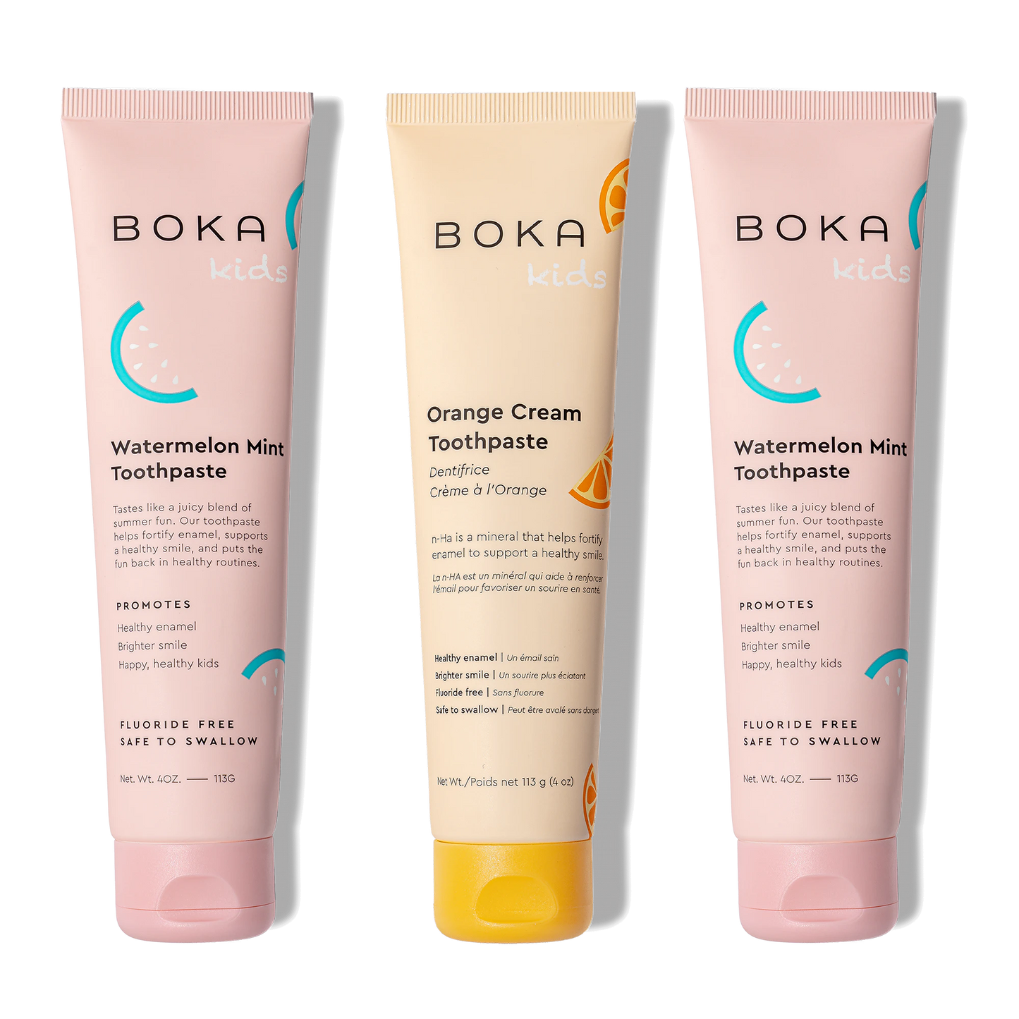 Three tubes of Boka toothpaste, two pink and one beige, on a white background.