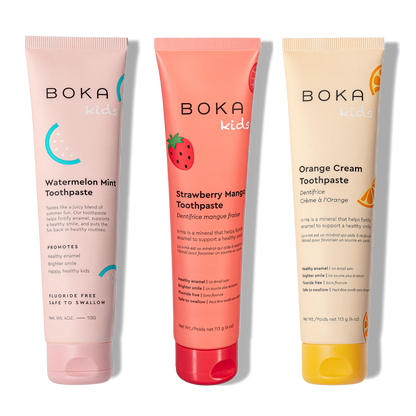 Three Boka toothpaste tubes in different flavors on a white background