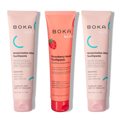 Three Boka toothpaste tubes in watermelon mint and strawberry mango flavors on a white background