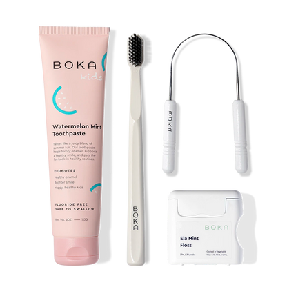 Starter Kit: toothpaste, toothbrush with charcoal bristles, tongue cleaner, and floss on white.